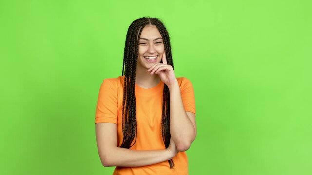 Teenager girl with braids standing and looking to the side over isolated background. Green screen chroma key