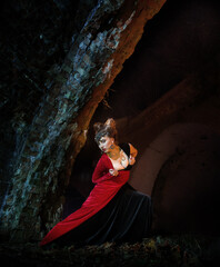 Passionate woman in the image of a witch, vampire or sorceress on Halloween night.