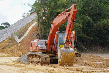 Heavy construction equipment excavator at road construction site.
