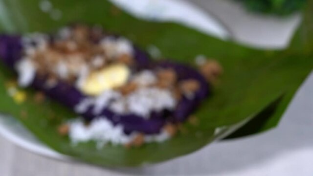 puto bumbong is a famous snack for Christmas season, it is a purple rice cooked in a tube and topped with margarine, mascovado sugar and grated coconut