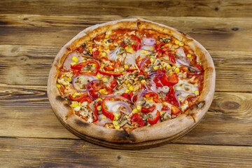 Delicious fresh pizza on a wooden table
