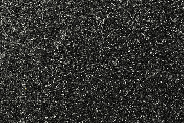 Black shining glowing effects concept, glitter texture background, sandpapper high detailed surface