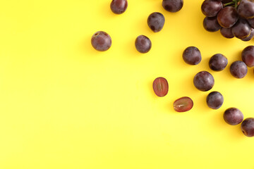 Red grapes isolated top view in yellow background