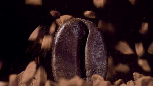 Caramel or chocolate pieces falling onto a coffee bean at 1000fps. Super slow 