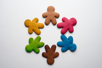 Gingerbread cookies in the shape of men of different colors - yellow, brown, red, blue, green. Christmas and new year traditions. The concept of united and friendship of the peoples of the world