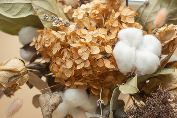 a bouquet of dry hydrangeas, cotton and palm leaves