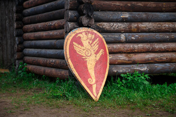 Reconstruction of middle ages - slavic shield near wooden fortress