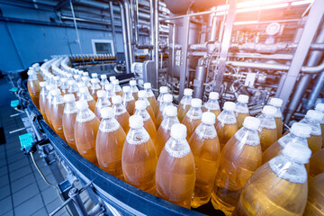 Conveyor belt with bottles for juice or water at a modern beverage plant