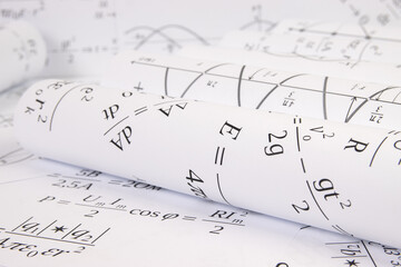 rolls of paper printed drawings with mathematical electrical formulas