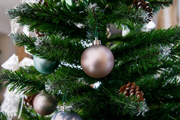 Shiny Christmas balls on pine branches
