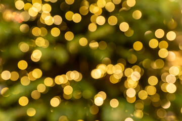 Bokeh abstract texture. Beautiful christmas background in golden colors. Defocused image