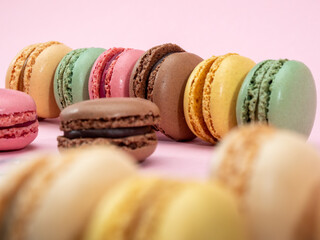 colorful macarons on pink background