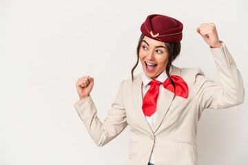 Young caucasian stewardess woman isolated on white background raising fist after a victory, winner concept.