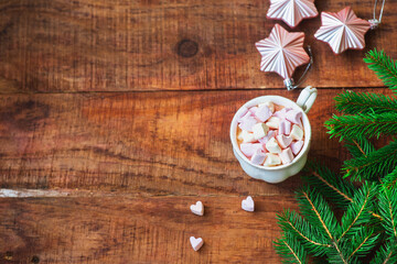Obraz na płótnie Canvas Christmas background. Composition of spruce branches Christmas balls, cup with coffee with marshmallows on a wooden background. Copy space Top view. Christmas or New Year's card. flat lay
