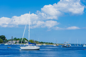 Several yachts and boats docked in the waters of the Merrimack River by the Atlantic Ocean in Newburyport, Massachusetts, USA