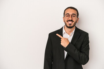 Young caucasian business man isolated on white background smiling and pointing aside, showing something at blank space.