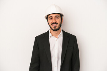 Young architect man wearing a construction helmet isolated on white background happy, smiling and cheerful.