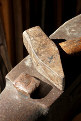 close-up old hammer in blacksmith workshop