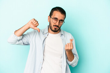 Fototapeta premium Young caucasian man isolated on blue background showing that she has no money.