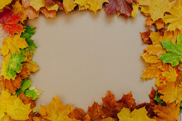 Naklejka na ściany i meble Colorful autumn leaves on kraft paper background.
