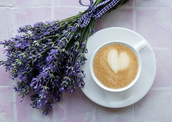 Cup of coffee with macaroon dessert with lavender flavor