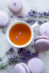 Cup of tea with macaroon dessert with lavender flavor