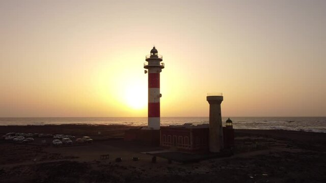 Aerial drone view of the Tost&oacute;n lighthouse at sunset, Punta Ballena, near the town of El Cotillo, Fuerteventura island, Canary Islands. Spain, 4k video