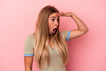 Fototapeta premium Young Russian woman isolated on pink background excited pointing with forefingers away.
