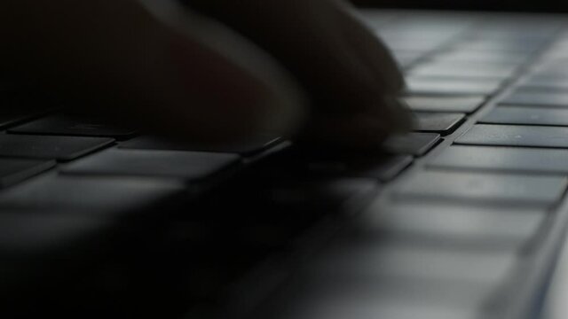 Macro View of Woman Fingers Typing Buttons on Laptop