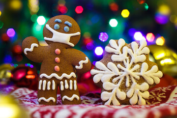 Christmas background with gingerbread man with protective medical mask. Happy New Year festive background