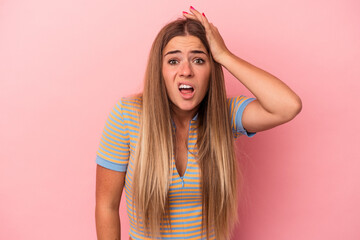 Young Russian woman isolated on pink background cheerful smiles pointing to front.