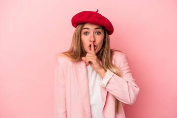 Young Russian woman isolated on pink background surprised pointing with finger, smiling broadly.