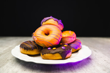 halloween donut on the plate with black wooden texture background