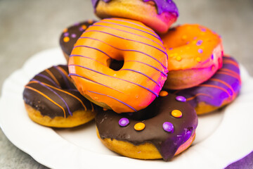 halloween donut on the plate with light wooden texture background