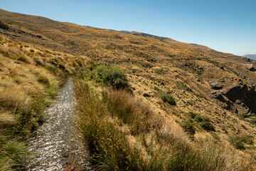 One of the ancient water channel (Acequias) of the Poqueira valley, Las Alpujarras, Sierra Nevada National Park, Andalusia, Spain