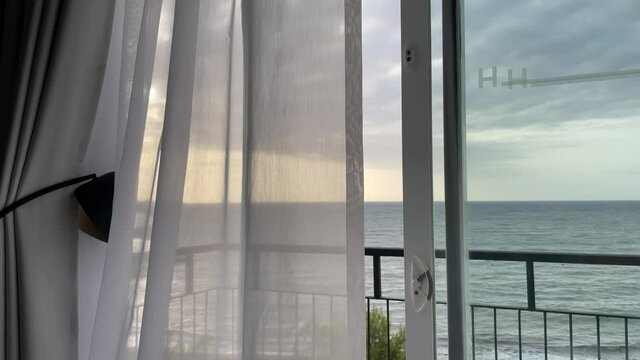 Curtain in the wind with a view