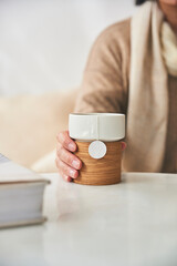 Woman's hand holding a tea cup in tea shop