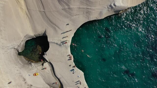 Aerial drone top down still video from famous white chalk volcanic bay and caves of Sarakiniko, Milos island, Cyclades, Greece