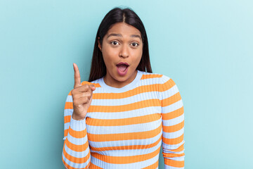 Young Venezuelan woman isolated on blue background having an idea, inspiration concept.