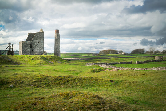 The Cornish engine house, circular chimney, pit-head gear and powder house at Magpie Mine, Sheldon, a preserved lead mine in the Peak District National Park