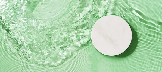 Transparent and clean blue water background with podium and sunlight reflection