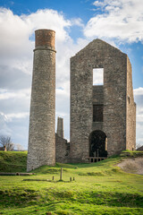 The Cornish engine house and circular chimney at Magpie Mine, Sheldon, a preserved lead mine in the Peak District National Park