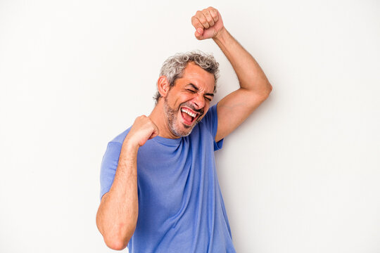 Middle Age Caucasian Man Isolated On White Background  Celebrating A Special Day, Jumps And Raise Arms With Energy.