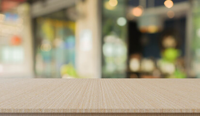 abstract blur modern interior of cafe restaurant with circle bokeh light and modern wood table perspective to show ads, and promote content or product on background