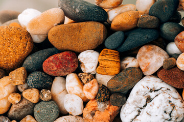 Colorful sea pebbles close-up. Background texture, sea stones in the water