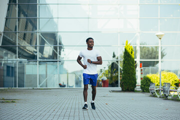 Fototapeta na wymiar man on morning run, young african american athlete running near stadium