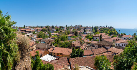 Fototapeta na wymiar old roofs of houses, the old kaleichi district in antalya. panorama. the historical center of Antalya, where there are many small hotels and restaurants, is a favorite place of travelers and tourists