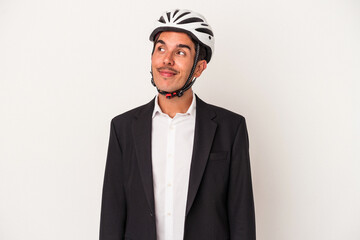 Young mixed race business man wearing a bike helmet isolated on white background dreaming of achieving goals and purposes