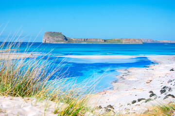 Amazing view of Balos Lagoon with magical turquoise waters, lagoons, tropical beaches of pure white sand and Gramvousa island on Crete, Greece