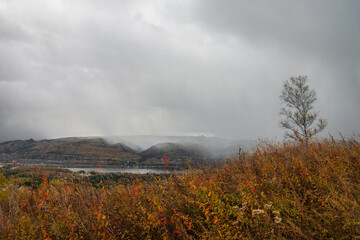 Snow storm over the river and mountains